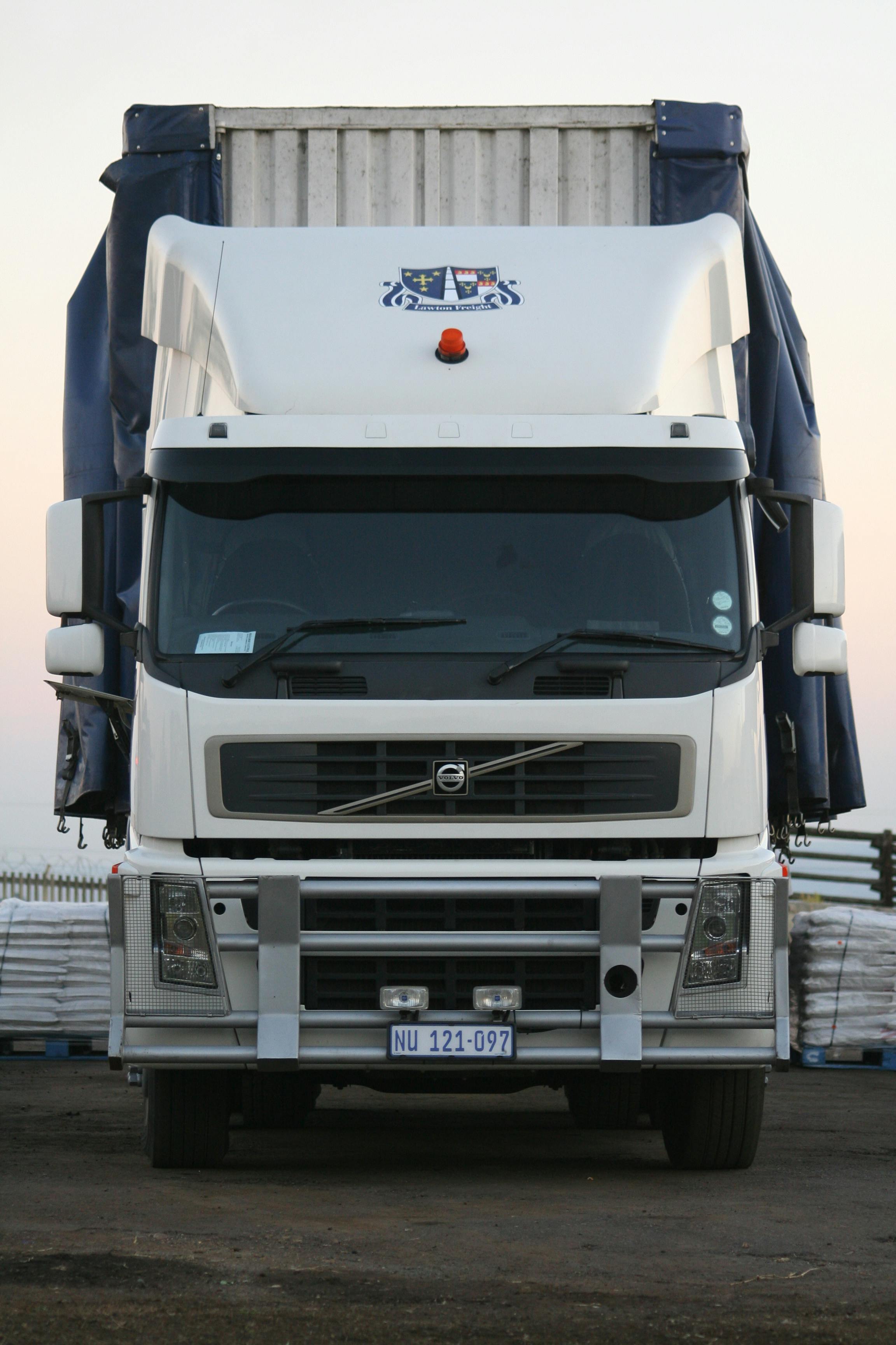 pexels-photo-14048025-14048025 A powerful white truck captured from the front, showcasing its robust design.